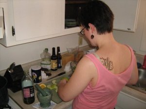 Me cooking with my shoulder tattoo showing: a large capital W and A surrounded by decorative vines.